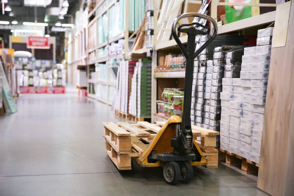how much does a pallet jack weigh (2) A pallet jack in the warehouse.