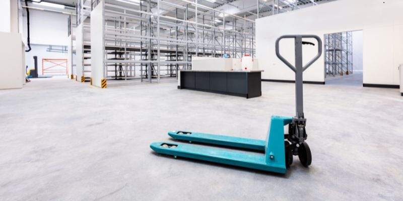 euro-pallets2 Blue pallet jack in a clean warehouse ready for loading euro pallets onto shelves